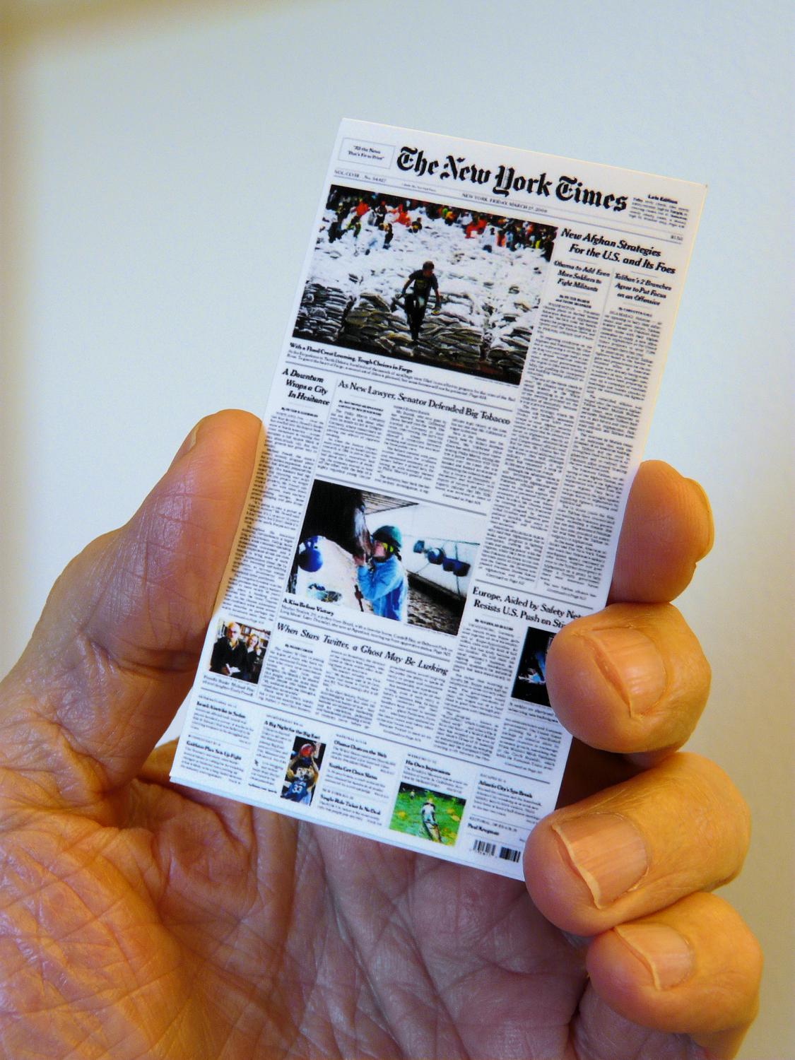 Hand holding nano edition of the NY Times - The 'Nano' edition takes the New York Times from print to squint. - Tony Karp, design, art, photography, techno-impressionist, techno-impressionism, aerial photography , drone , drones , dji , mavic pro , video , 3D printing - Books -